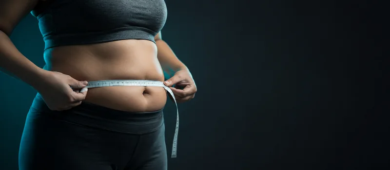 Measuring waist circumference with a tape measure — the main sign of abdominal obesity